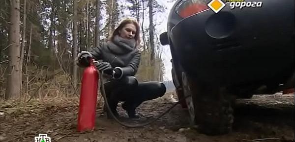  Girl in leather pants has a problem with a car